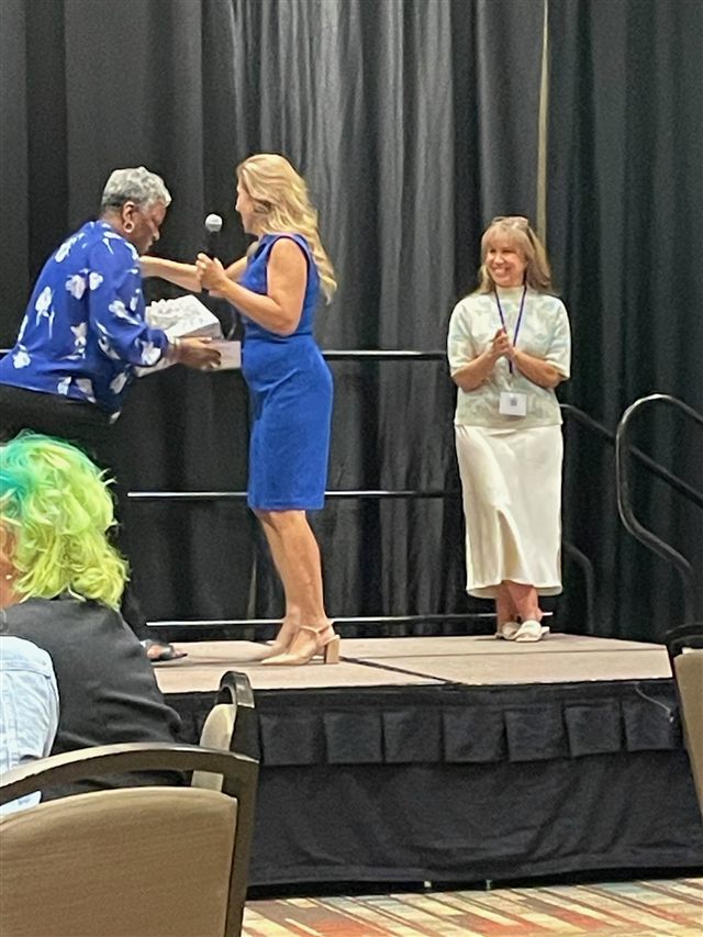 Regina being presented with a gift during the New Mexico conference.